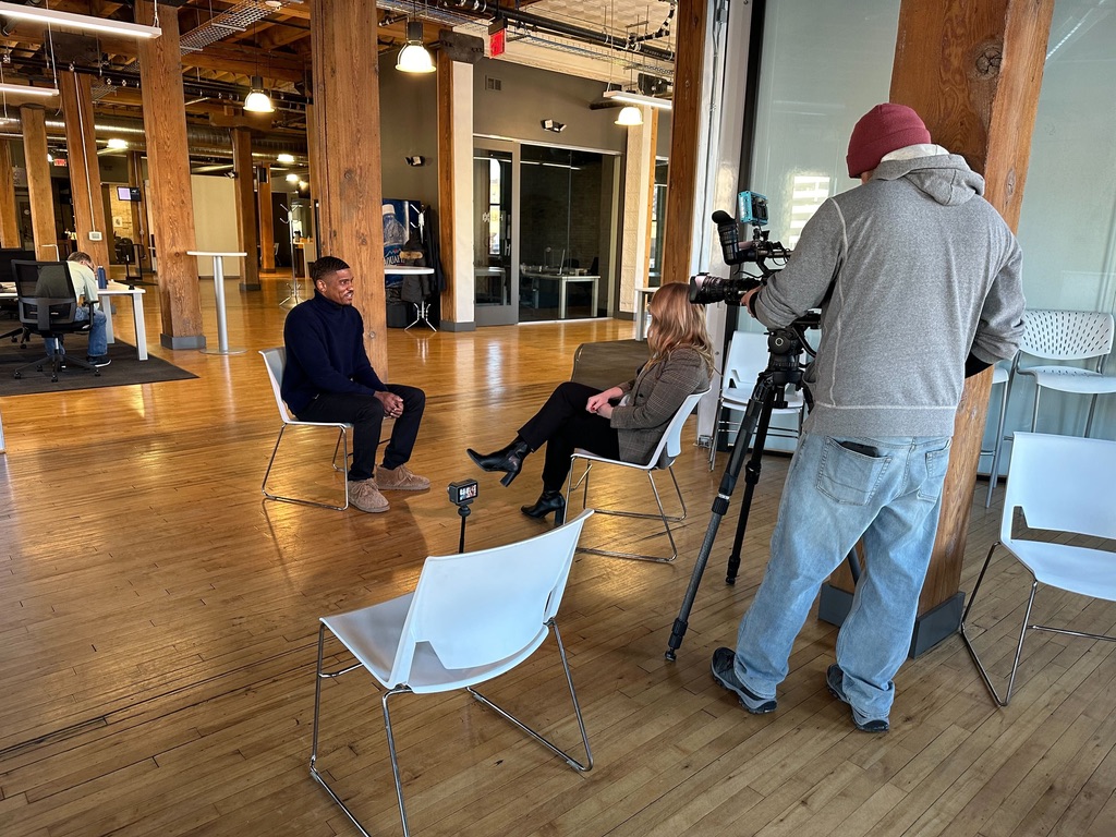 Justin Howell speaking with a reporter during a venture capital interview