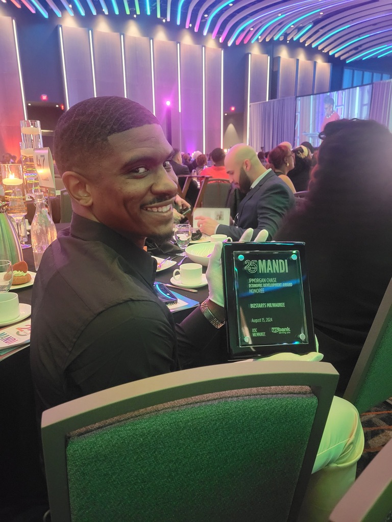 Justin Howell holding his 2024 MANDI economic development award
